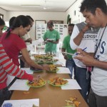 Farmers and MAF-SoL researchers tasting the different sweet potato varieties