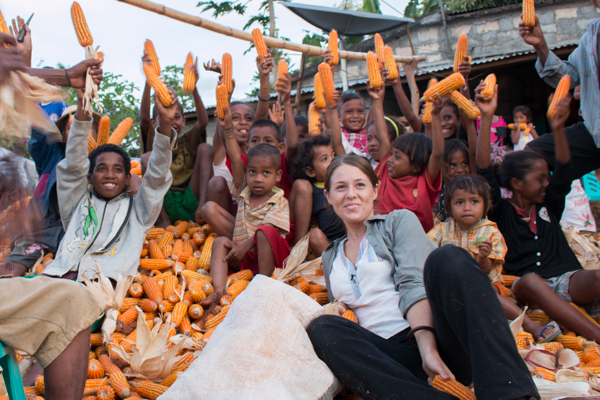 Host Leesa sits on a mountain of corn with family members of the Raimean commercial seed producer group in Baucau district © Jessy Betty/Seeds of Life